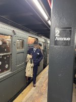 People dessed up in amazing costumes posing next to the NYCTA Holiday Train at 2nd Avenue Station on Manhattans Lower East Side